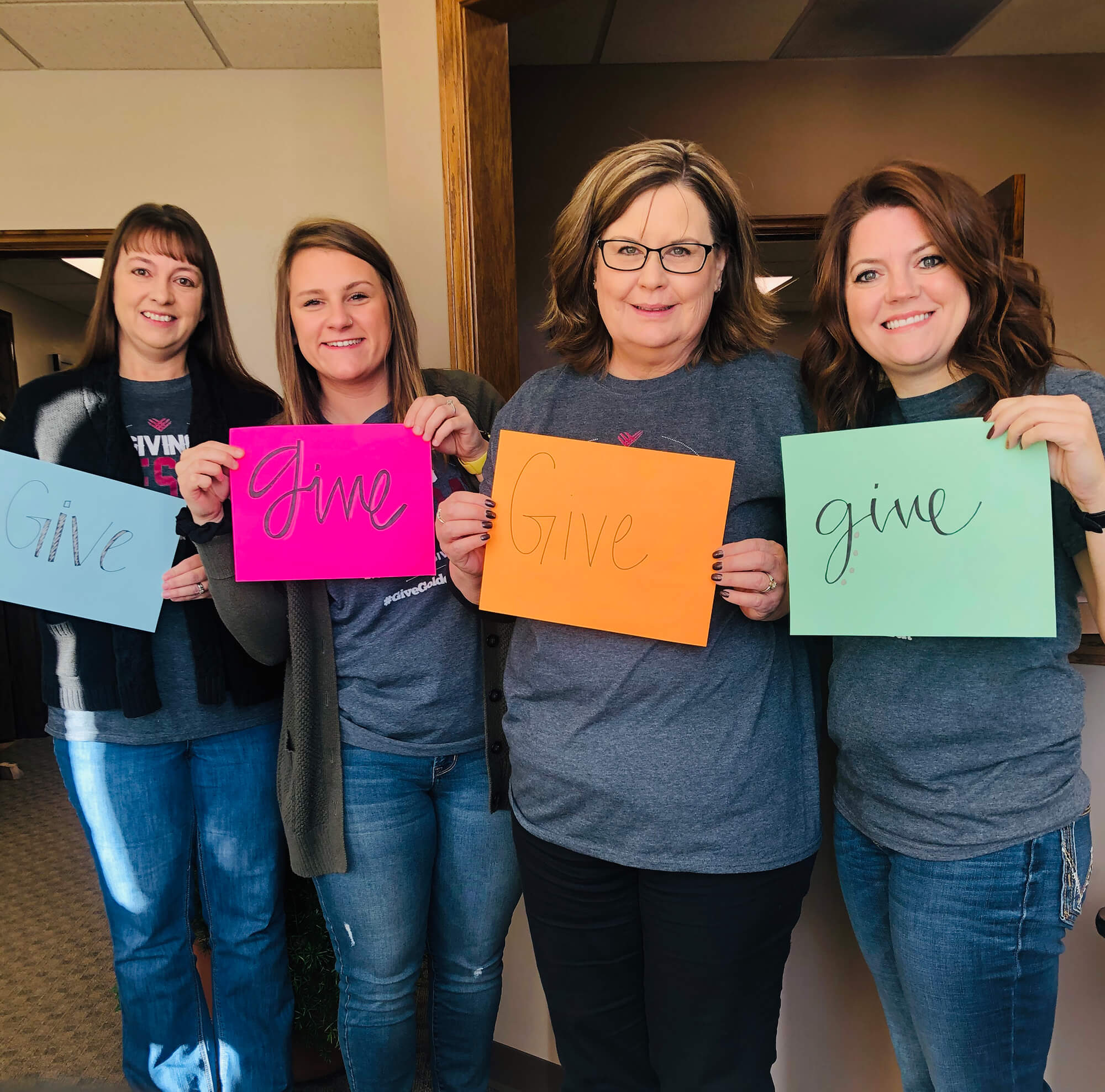 women holding give signs